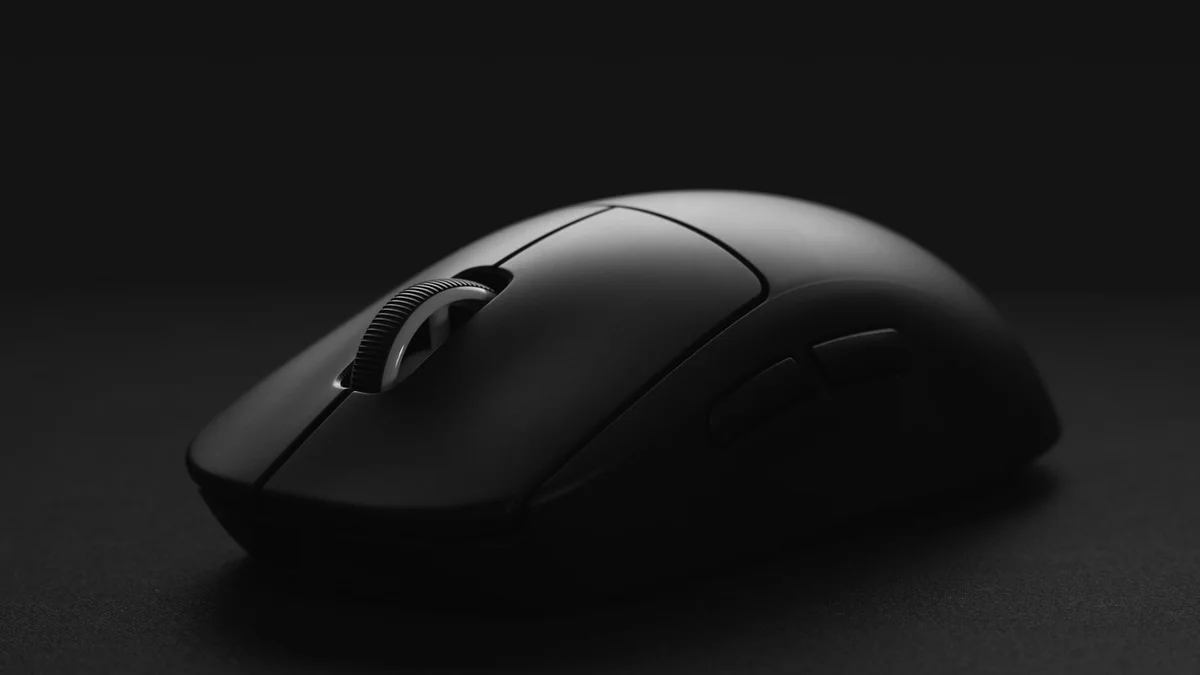 Logitech MX Master 3S wireless mouse on desk mat next to keyboard